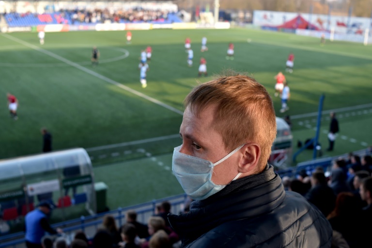 Un supporter du FC Minsk, portant un masque à Minsk 28 mars 2020 alors que le championnat de football du Bélarus continue malgré la pandémie de coronavirus